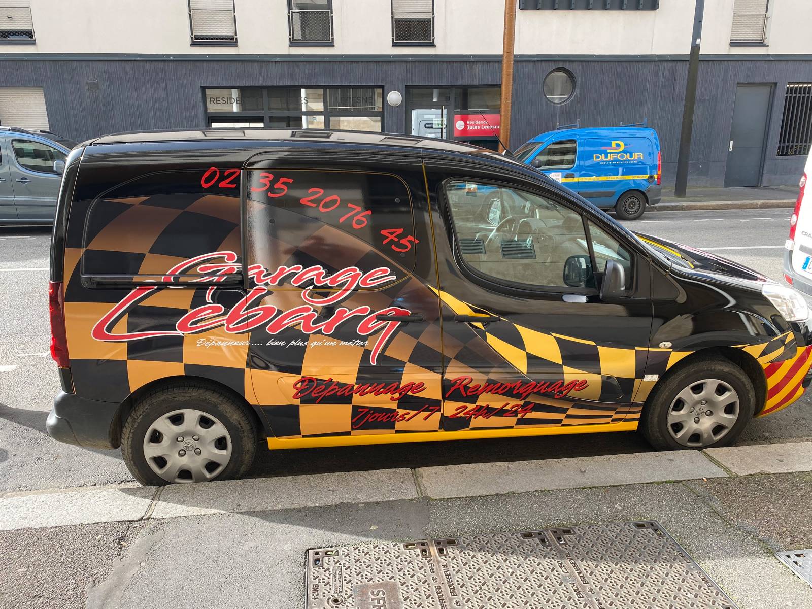 Covering publicitaire d'un utilitaire noir pour le Garage Lebarq à Gonneville-la-Mallet
